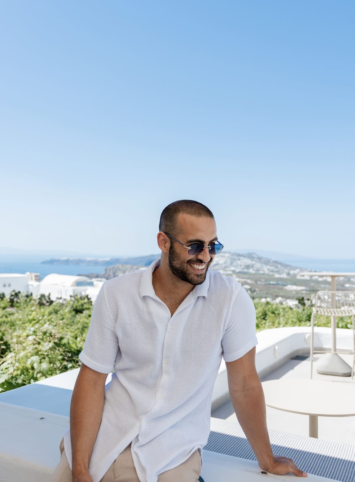 Alexandros Sirigos, Santorini photographer, on a white terrace above Fira